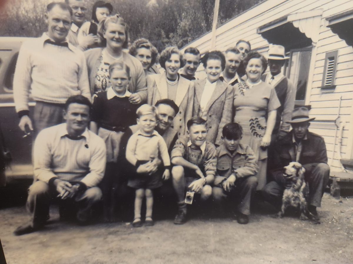 A creased, faded print of a large family gathering